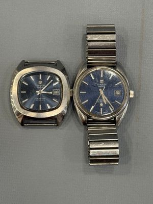 two watches sitting next to each other on a table
