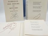 three books with drawings on them sitting on a table