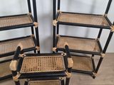 three black and wicker shelves with rattans on them