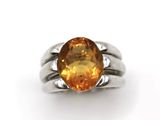 a close up of a ring with an orange stone on it