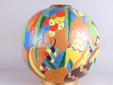 a colorful vase that is sitting on a table