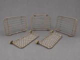 four metal trays with handles and handles on a gray surface
