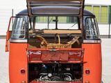 an orange vw bus parked in a parking lot with its trunk open