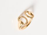a close up of a gold ring on a white surface