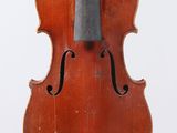an old violin with a bow hanging from it ' s back