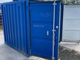 a blue container sitting next to a white door