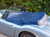 a blue sports car with a blue cover on the roof
