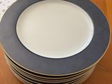 a stack of plates sitting on a table with a tag on it