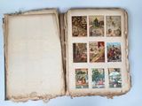 an open book with pictures of people and animals on it on a table