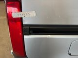 a sticker on the back of a silver truck