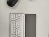 a keyboard and a mouse on a table next to each other