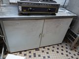 an image of a kitchen with a stove and a cabinet