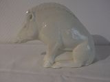 porcelain figurine of a white pig sitting on a white surface