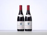 deux bouteilles de vin rouge posées l'une à côté de l'autre sur une table