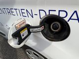a white car with a blue and white sign on the side of it