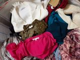 a basket full of clothes and a teddy bear in it