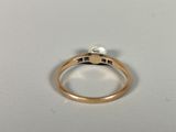 an image of a gold ring with a pearl in it