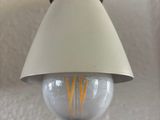 a light that is on on the wall next to a lamp