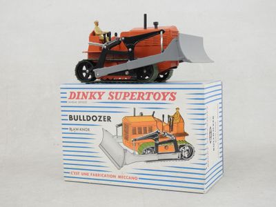 a toy tractor with a man on top of it in a box