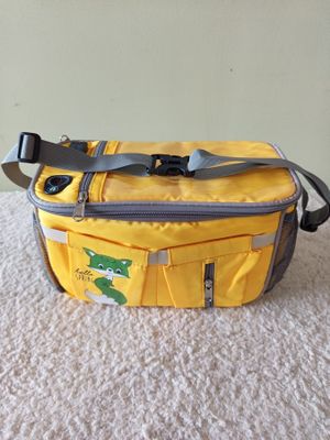 a yellow bag that has a green frog on it