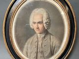 portrait of a man with a pipe in his mouth in a gold frame