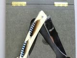 a picture of a pair of shoes and a knife in a box