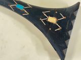 a black horn with a bug on it on a white surface