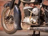 a motorcycle that is parked in front of a brick wall