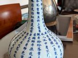 a blue and white vase sitting on a table