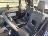 the interior of a vehicle with two seats and a steering wheel