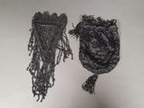 pair of black beaded purses with tassels hanging from them