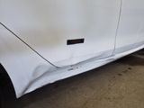 a white car with a sticker on the side of it
