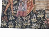 a tapestry with a picture of a man and a woman in a garden