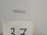someone is holding a piece of paper with the number 37 on it