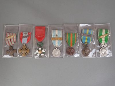 several medals and medals are displayed in a display case