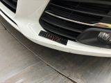 a close up of a car ' s grille with a sticker on it