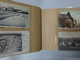 an open book with pictures of buildings and a river in the background