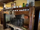 a fireplace in the middle of a room with a shelf above it