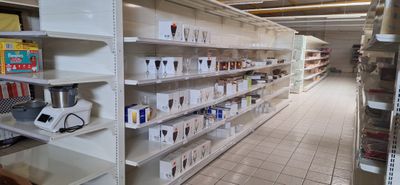 de nombreux rayons dans le magasin, sur lesquels sont disposés différents articles