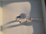 a ring that is sitting in a box with a diamond on it