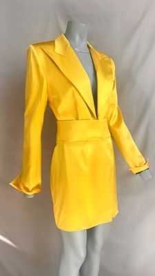 a mannequin wearing a yellow jacket and skirt on a mannequin mannequin mannequin mannequin mannequin mannequin manne