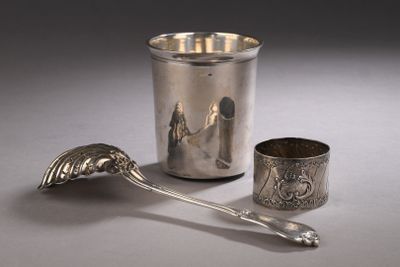 une tasse et une cuillère en argent posées l'une à côté de l'autre sur une table