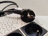 wires and plugs plugged into a power strip on top of a computer keyboard