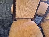 four chairs are lined up in a row on a carpeted floor