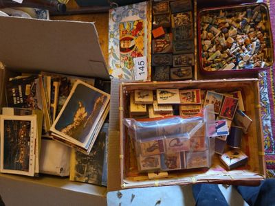 a box full of postcards and other items on the floor