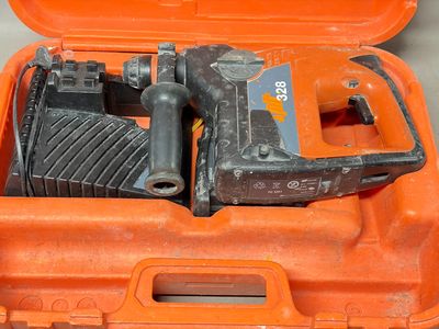 an orange tool case with a hammer and other tools in it