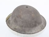 an old helmet is sitting on a stand on a white surface