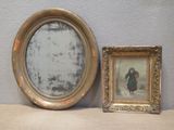 a mirror and a picture frame sitting on a shelf