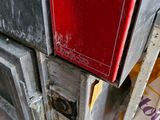 a red refrigerator sitting on the side of a building