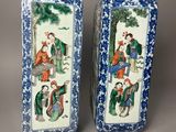 pair of chinese blue and white vases with figures on them
